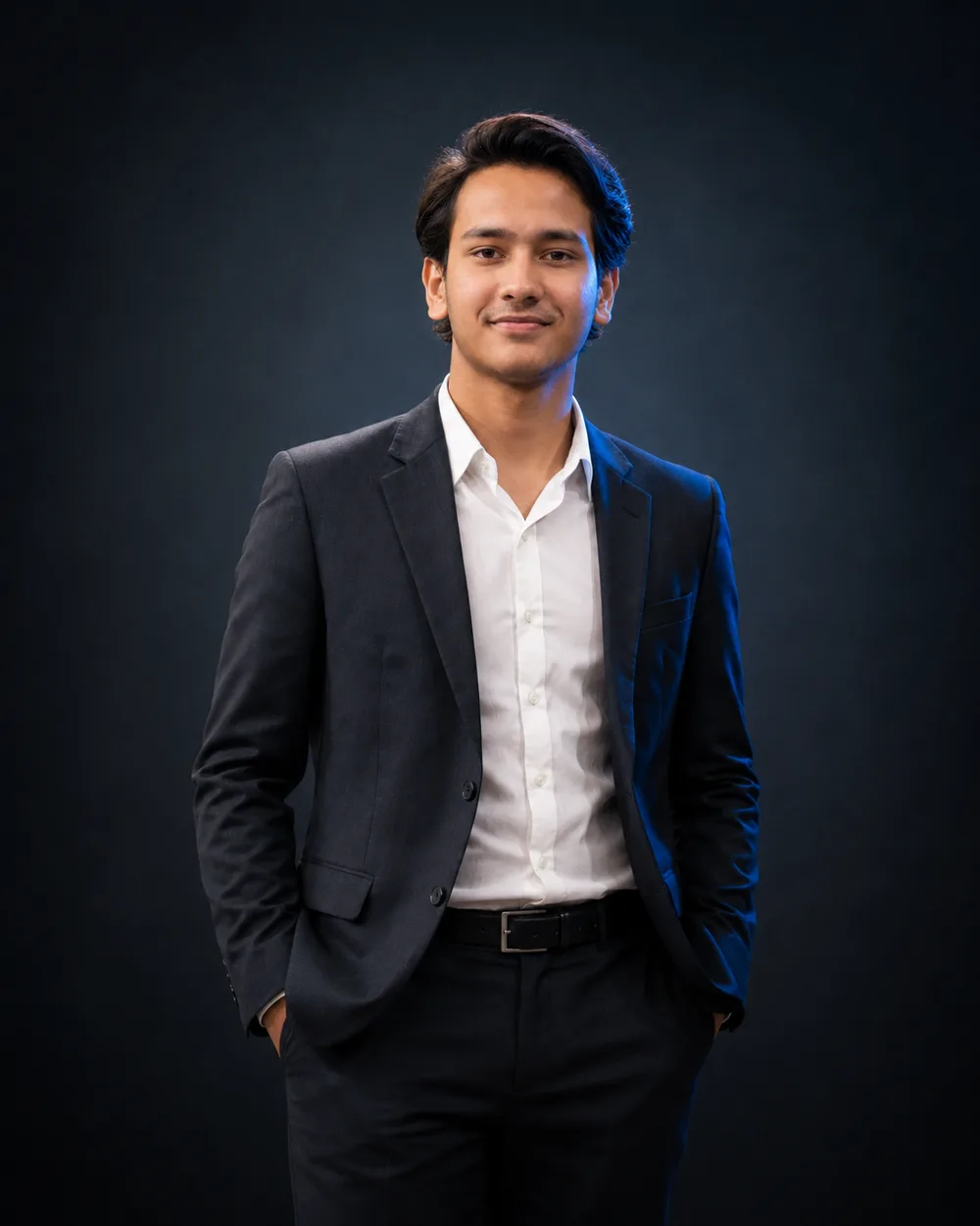 Mahad Usman, a web and AI developer, in a dark suit lit against a near-black background.